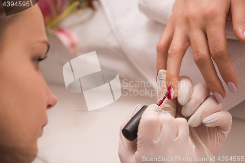 Image of Woman hands receiving a manicure