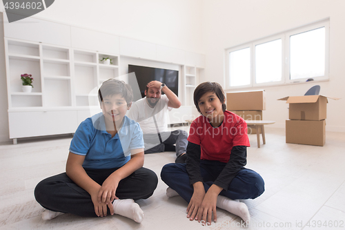 Image of portrait of happy young boys with their dad