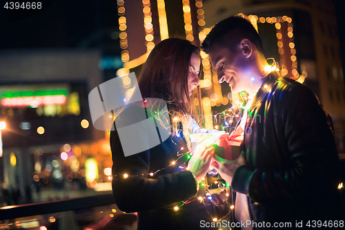 Image of romantic surprise for Christmas, woman receives a gift from her boyfriend