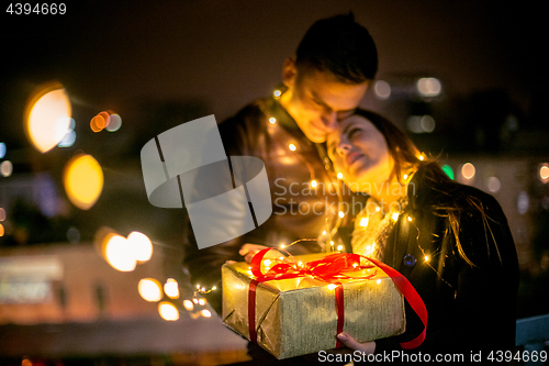 Image of romantic surprise for Christmas, woman receives a gift from her 