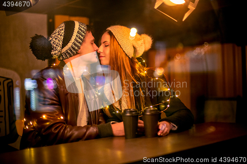 Image of Young couple kissing and hugging outdoor in night street at christmas time