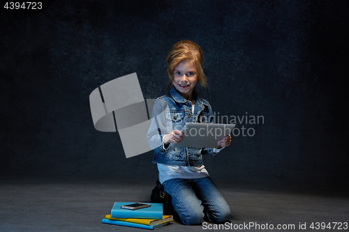 Image of Little girl sitting with tablet