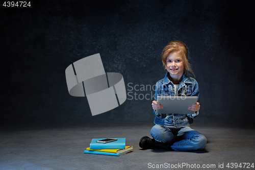 Image of Little girl sitting with tablet