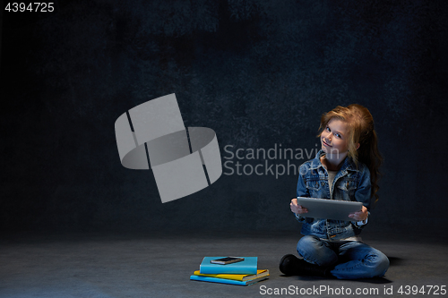 Image of Little girl sitting with tablet