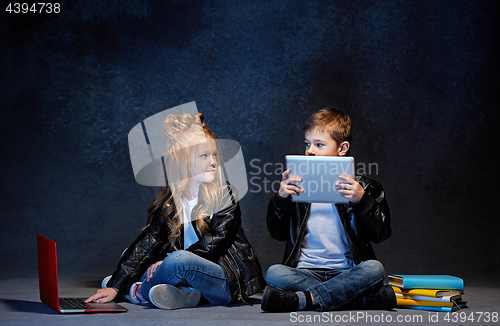 Image of Studio shot of two children with laptop