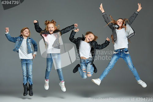 Image of Young girl jumping at studio