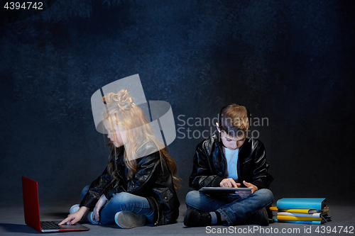 Image of Studio shot of two children with laptop