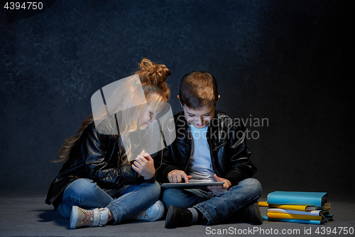 Image of Studio shot of two children with laptop