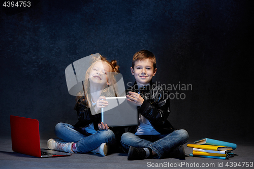 Image of Studio shot of two children with laptop