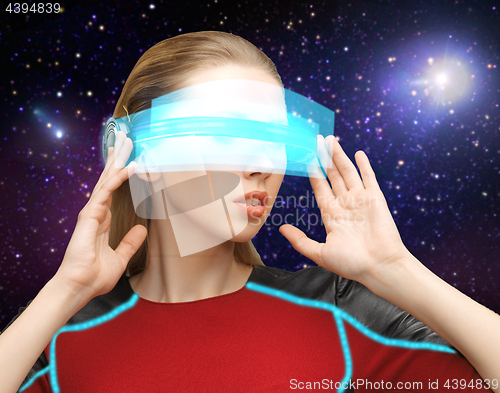 Image of woman in virtual reality glasses over space