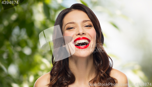 Image of beautiful laughing young woman with red lipstick