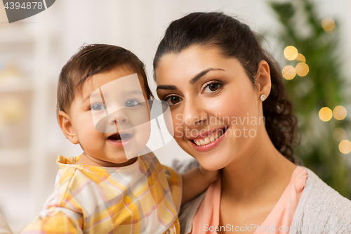 Image of portrait of happy mother with baby daughter