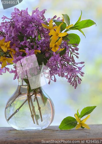 Image of Lilac bouquet on the wooden table