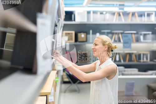 Image of Beautiful young woman shopping in retail store.