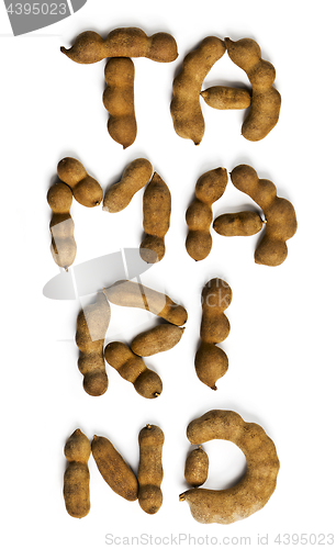 Image of Word tamarind made of tamarind fruits. Top view  