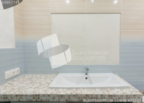 Image of Newly mounted pedestal under the sink, on the tile is left a place under the mirror