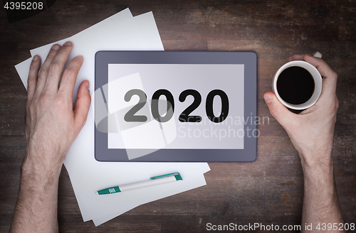 Image of Tablet touch computer gadget on wooden table - 2020