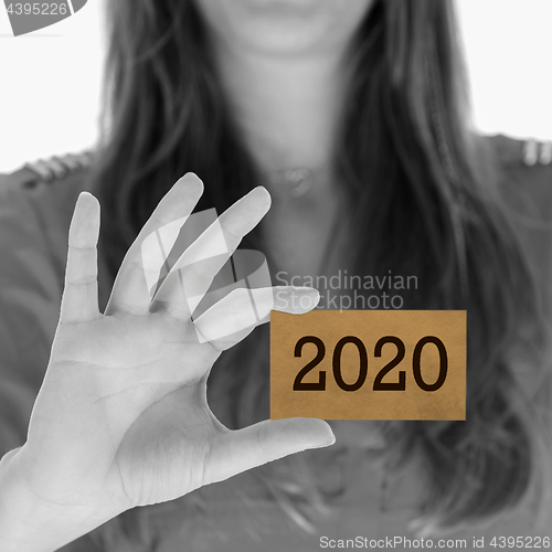 Image of Woman showing a business card - 2020