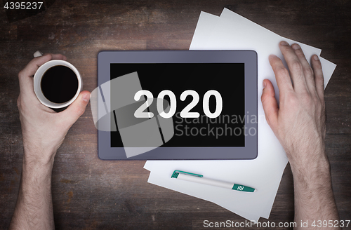 Image of Tablet touch computer gadget on wooden table - 2020