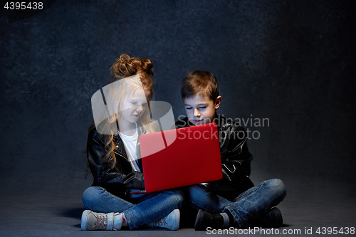 Image of Studio shot of two children with laptop