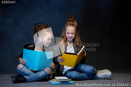 Image of Two kids reading the books at studio