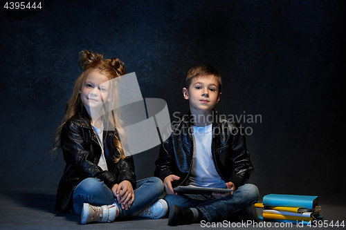 Image of Studio shot of two children with laptop