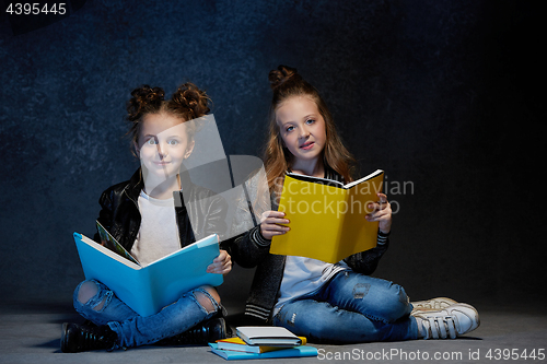Image of Two kids reading the books at studio
