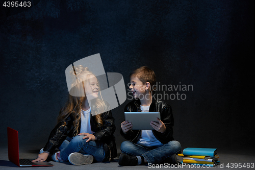 Image of Studio shot of two children with laptop