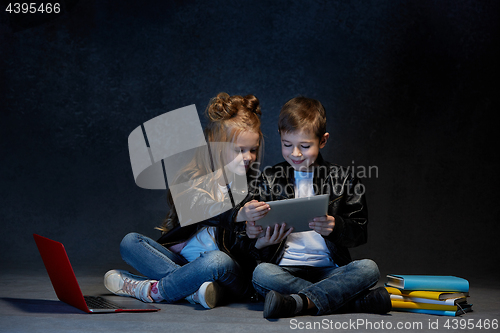 Image of Studio shot of two children with laptop