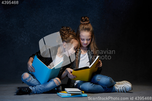 Image of Two kids reading the books at studio