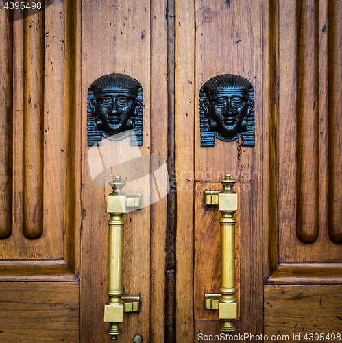 Image of Sphinx heads entrance on wooden door