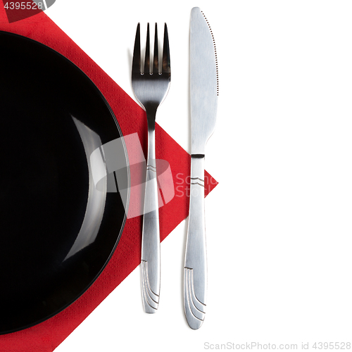 Image of Plate, knfie and fork on a napkin.