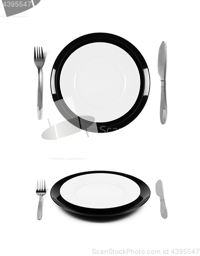 Image of Black and white plates with fork and knife