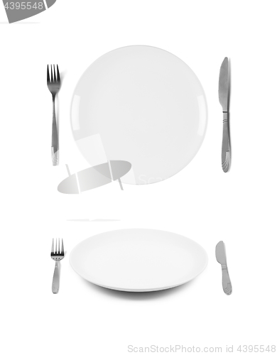 Image of White plates with fork and knife