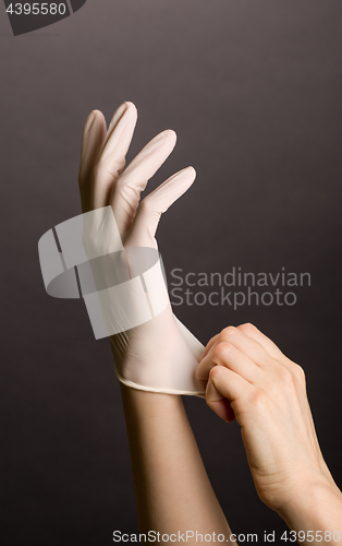 Image of Putting on latex gloves