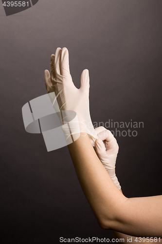 Image of Putting on latex gloves