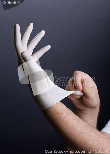 Image of Putting on latex gloves