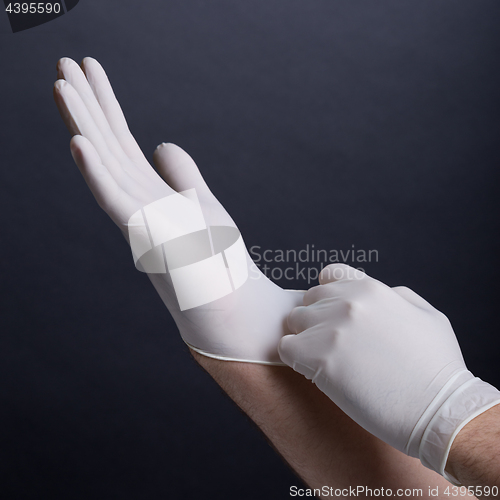 Image of Putting on latex gloves