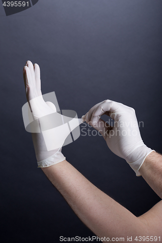Image of Male hands in latex gloves