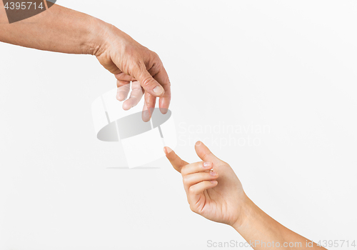 Image of close up of senior and young woman hands