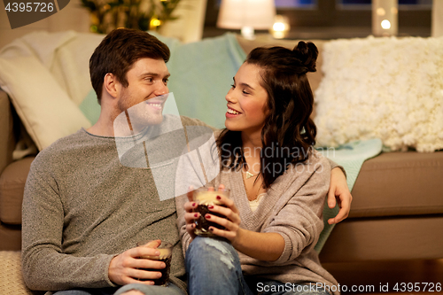 Image of happy couple drinking coffee and eating at home