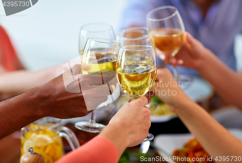 Image of hands clinking wine glasses