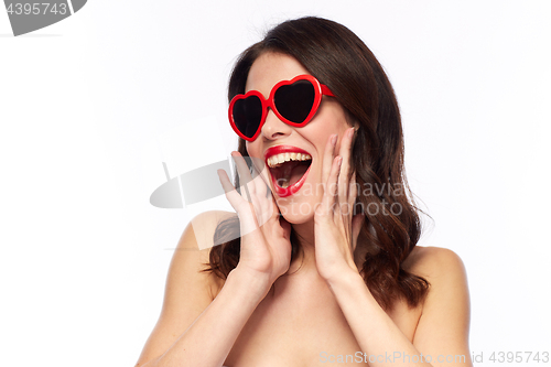 Image of woman with red lipstick and heart shaped shades