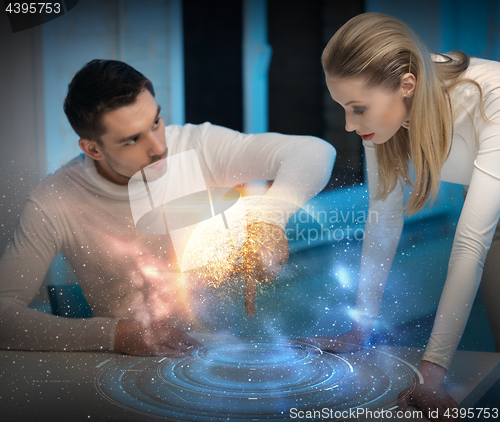 Image of couple using touch screen over space background