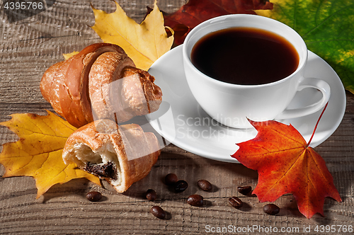 Image of Cup of black coffee with croissants