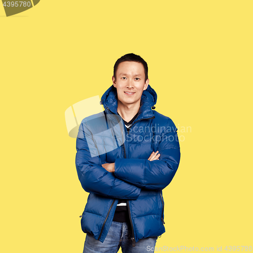 Image of Asian man in blue down-padded coat