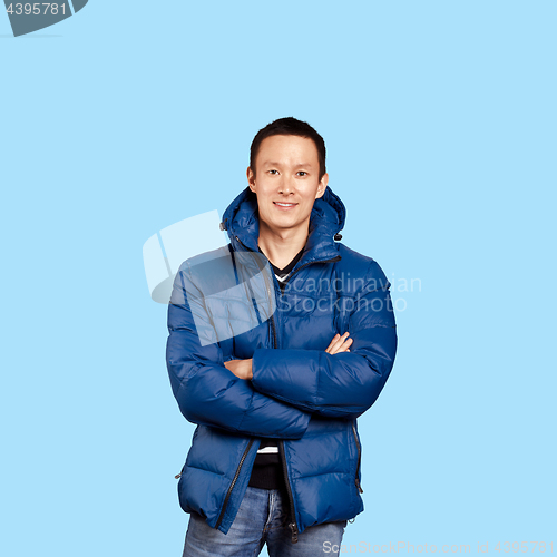 Image of Asian man in blue down-padded coat