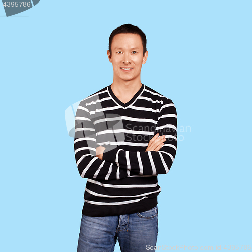 Image of Asian man in striped pullovert