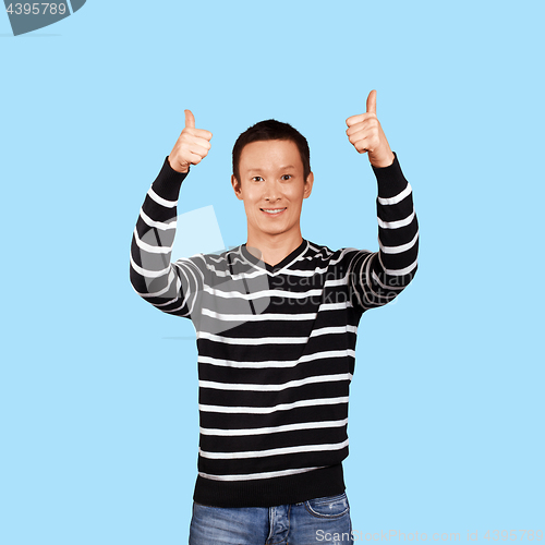 Image of Asian man showing well done with both hands