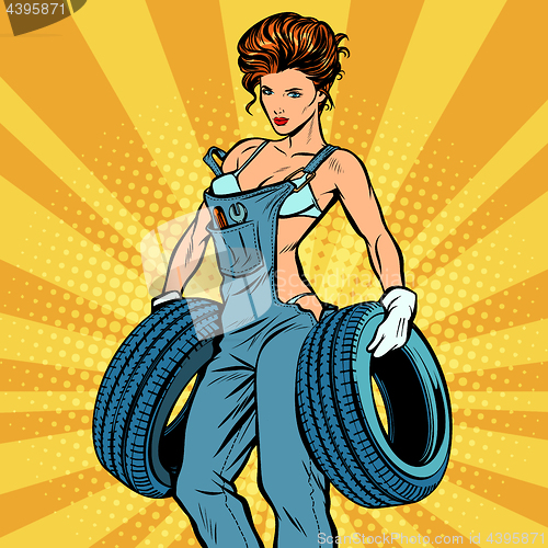 Image of woman in overalls with tires, car service